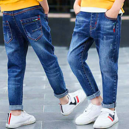 Kids wearing stylish blue jeans with rolled cuffs and white sneakers, perfect for casual fashion