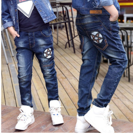 Kids' denim jeans with star patch design, paired with white sneakers for casual fashion