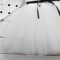 White tulle skirt with black ribbon and polka dot top, elegant children's fashion