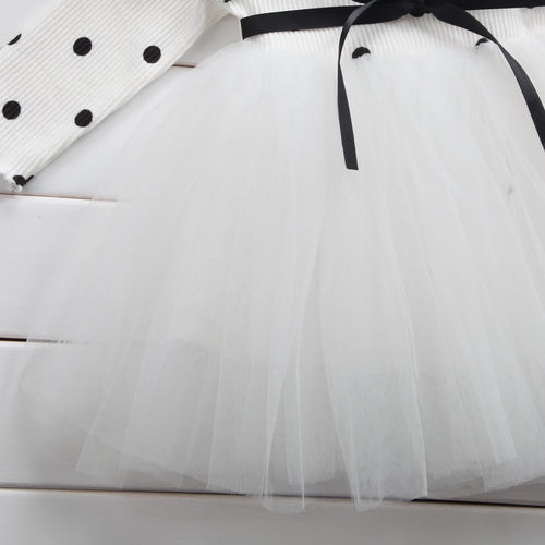 White tulle skirt with black ribbon and polka dot top, elegant children's fashion