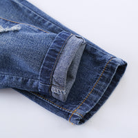 Distressed blue denim jeans with rolled cuff and orange stitching, premium fashion wear