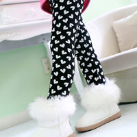 White fuzzy winter boots with black heart print leggings for kids