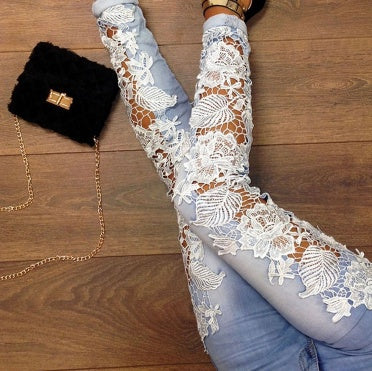 White lace thigh-high stockings with floral pattern, paired with denim jeans and black fur clutch on wood floor