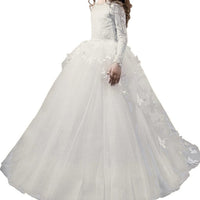 Elegant white flower girl dress with lace sleeves and tulle skirt, perfect for weddings and special occasions.