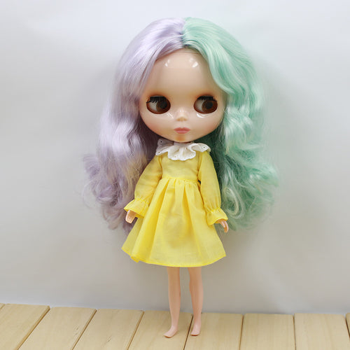 Collectible doll with pastel purple and mint hair, wearing yellow dress with white collar, ideal gift