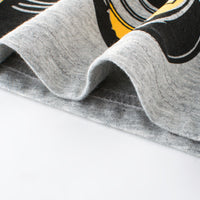Gray graphic t-shirt with bold black and yellow print, soft cotton fabric detail