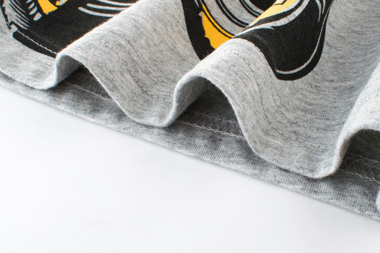 Gray graphic t-shirt with bold black and yellow print, soft cotton fabric detail