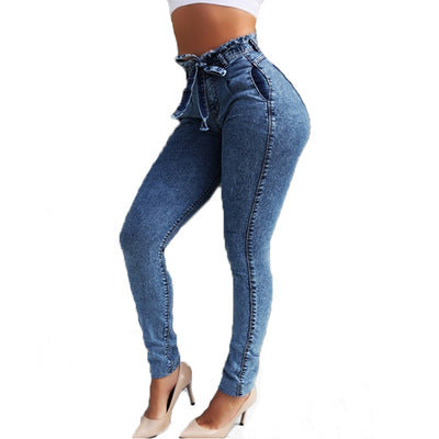 High-waisted skinny jeans with drawstring waist, blue denim, paired with heels