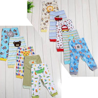 Colorful kids' pajama pants with animal, sports, and alphabet prints on white wood background