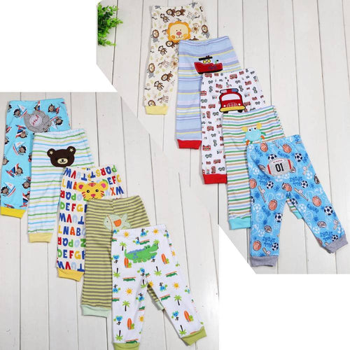 Colorful kids' pajama pants with animal, sports, and alphabet prints on white wood background