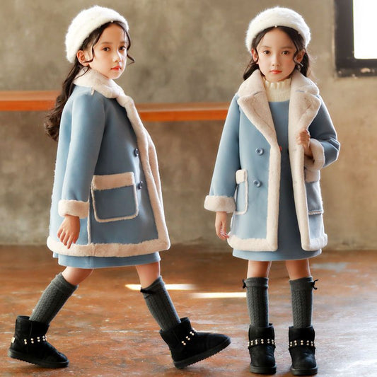 Girls in cozy blue winter coats with faux fur trim, matching hats, and black boots