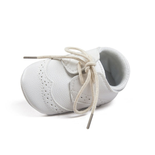 White baby shoes with lace-up design, soft sole for infants, perfect for first steps and special occasions