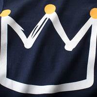 Navy blue t-shirt with white crown graphic and gold dots, stylish fashion apparel