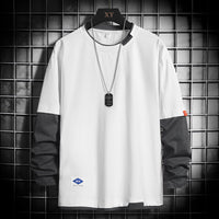 White long-sleeve color-block t-shirt with black sleeves, dog tag necklace, displayed on hanger against grid wall