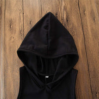 Black hooded sleeveless top on wooden background, stylish casual fashion