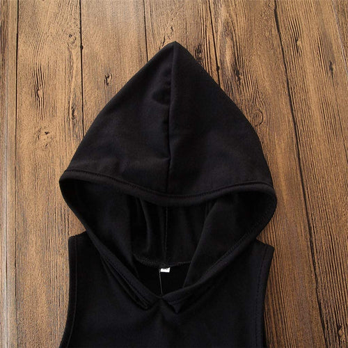 Black hooded sleeveless top on wooden background, stylish casual fashion