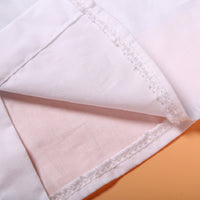 Soft white cotton fabric with delicate stitching, ideal for premium fashion apparel