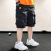 Black cargo shorts with smiley patch, worn with white sneakers and orange tee for kids' casual fashion