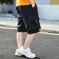 Black cargo shorts with orange zipper, paired with white sneakers, ideal for kids' casual summer wear