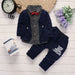 Baby boy outfit with navy blazer, polka dot shirt, red bow tie, and printed pants
