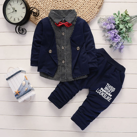 Baby boy outfit with navy blazer, polka dot shirt, red bow tie, and printed pants