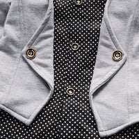 Gray cardigan with gold buttons over black polka dot blouse, stylish women's fashion outfit