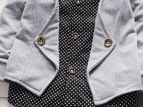 Gray cardigan with gold buttons over black polka dot blouse, stylish women's fashion outfit