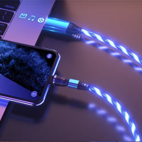 Glowing blue LED charging cable connecting smartphone to laptop, sleek tech accessory for modern devices