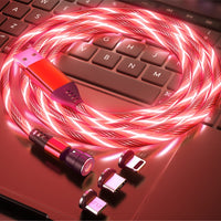 Glowing red LED USB charging cable with multiple connectors on laptop keyboard