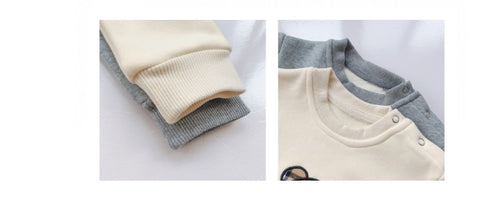 Cream and gray baby long-sleeve onesies with ribbed cuffs and snap buttons, soft cotton fabric