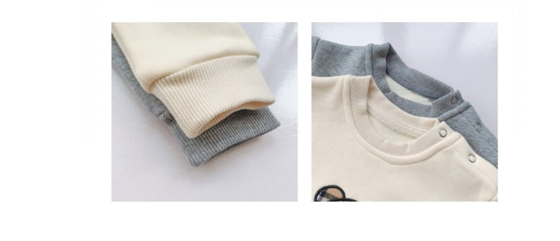 Cream and gray baby long-sleeve onesies with ribbed cuffs and snap buttons, soft cotton fabric