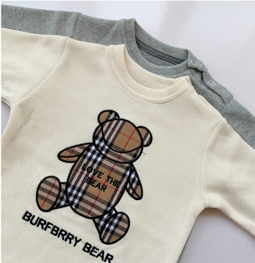 Cream baby onesie with plaid teddy bear graphic, 'Love the Bear' text, and 'BURBERRY BEAR' print