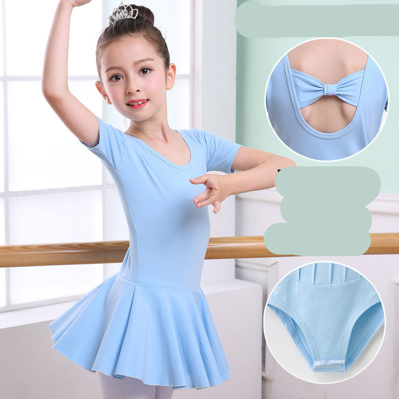 Girl in light blue ballet leotard with skirt, bow back detail, and matching briefs, posing at dance barre