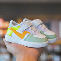 Colorful toddler sneakers with velcro straps, pastel green, yellow, orange, and white design