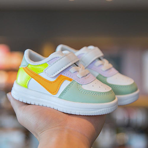 Colorful toddler sneakers with velcro straps, pastel green, yellow, orange, and white design