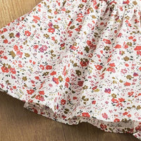 White floral dress with red and green blossoms, soft cotton fabric, perfect for spring fashion