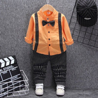 Orange kids shirt with black suspenders, striped pants, bow tie & white sneakers — stylish toddler outfit