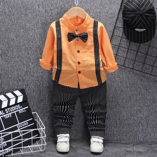 Orange kids shirt with black suspenders, striped pants, bow tie & white sneakers — stylish toddler outfit