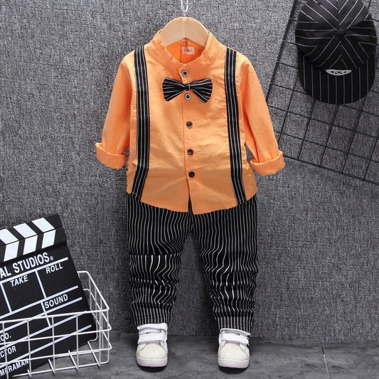 Orange kids shirt with black suspenders, striped pants, bow tie & white sneakers — stylish toddler outfit
