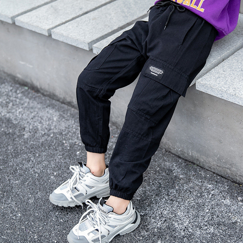 Teenager middle school student wearing black workwear leggings from Ancient Energy, suitable for elementary school children.