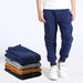 Young boy wearing Ancient Energy boys' sports trousers, athletic fit with adjustable waistband and breathable fabric.