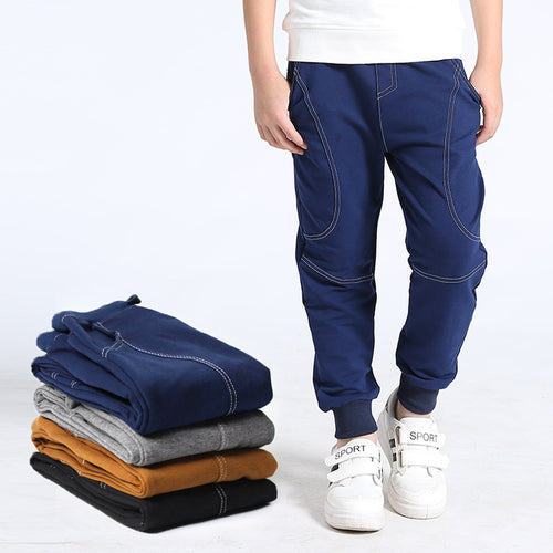 Young boy wearing Ancient Energy boys' sports trousers, athletic fit with adjustable waistband and breathable fabric.