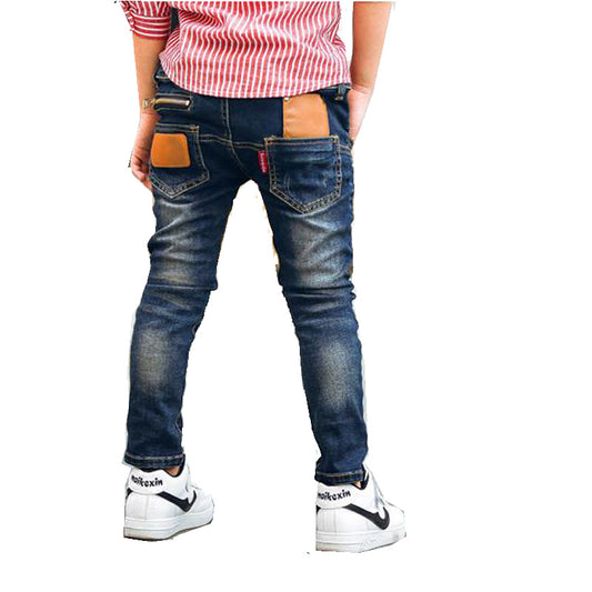 Boy wearing Ancient Energy stretch denim pants, casual boys' jeans with a comfortable fit and classic blue denim look.