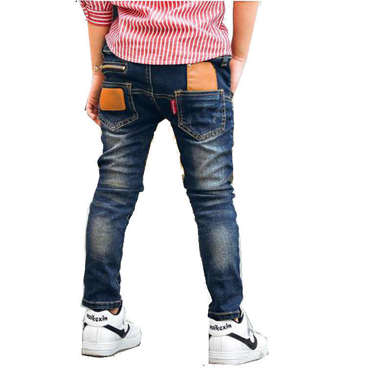 Boy wearing Ancient Energy stretch denim pants, casual boys' jeans with a comfortable fit and classic blue denim look.
