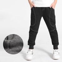 Boy wearing Ancient Energy boys' sports trousers, showing the athletic fit and breathable fabric in action.