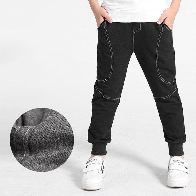 Boy wearing Ancient Energy boys' sports trousers, showing the athletic fit and breathable fabric in action.