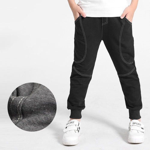 Boy wearing Ancient Energy boys' sports trousers, showing the athletic fit and breathable fabric in action.