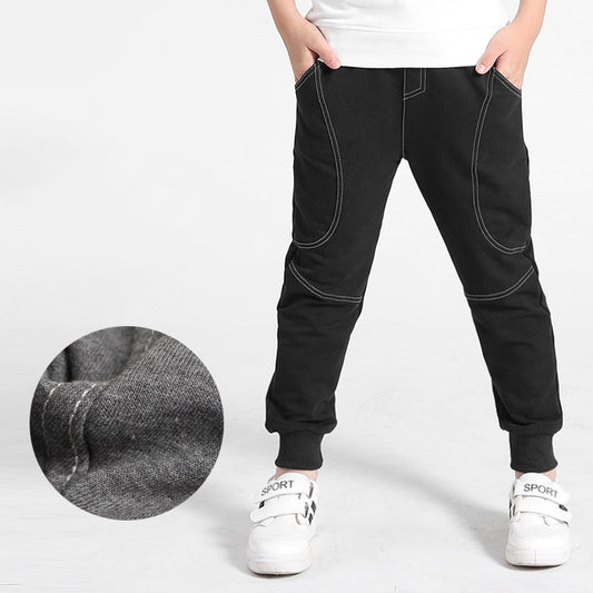 Boy wearing Ancient Energy boys' sports trousers, showing the athletic fit and breathable fabric in action.