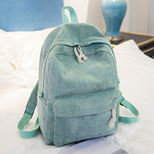 Ancient Energy corduroy backpack for students with shoulder straps, ideal for school and casual use.