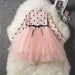 Baby girl in a long sleeve lace tutu dress by Ancient Energy, perfect for spring, winter, or birthday celebrations.
